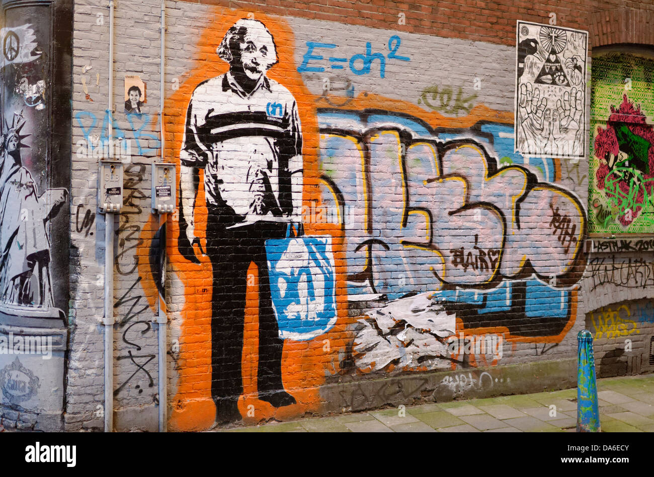 Street art or urban decay and vandalism, graffiti in Amsterdam, Holland, the Netherlands. Einstein shopping bag football shirt Stock Photo