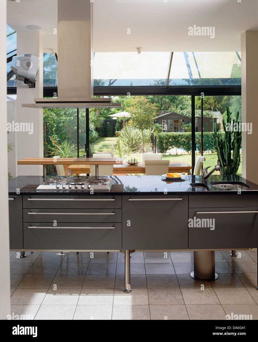 Extractor fan over gas hob in gray central island unit in contemporary