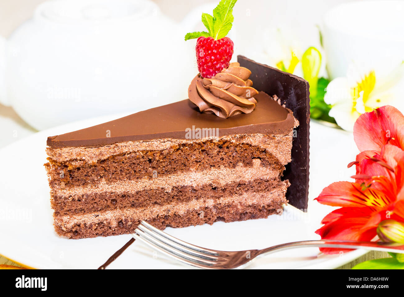 piece of chocolate cream cake on a white background in the restaurant ...