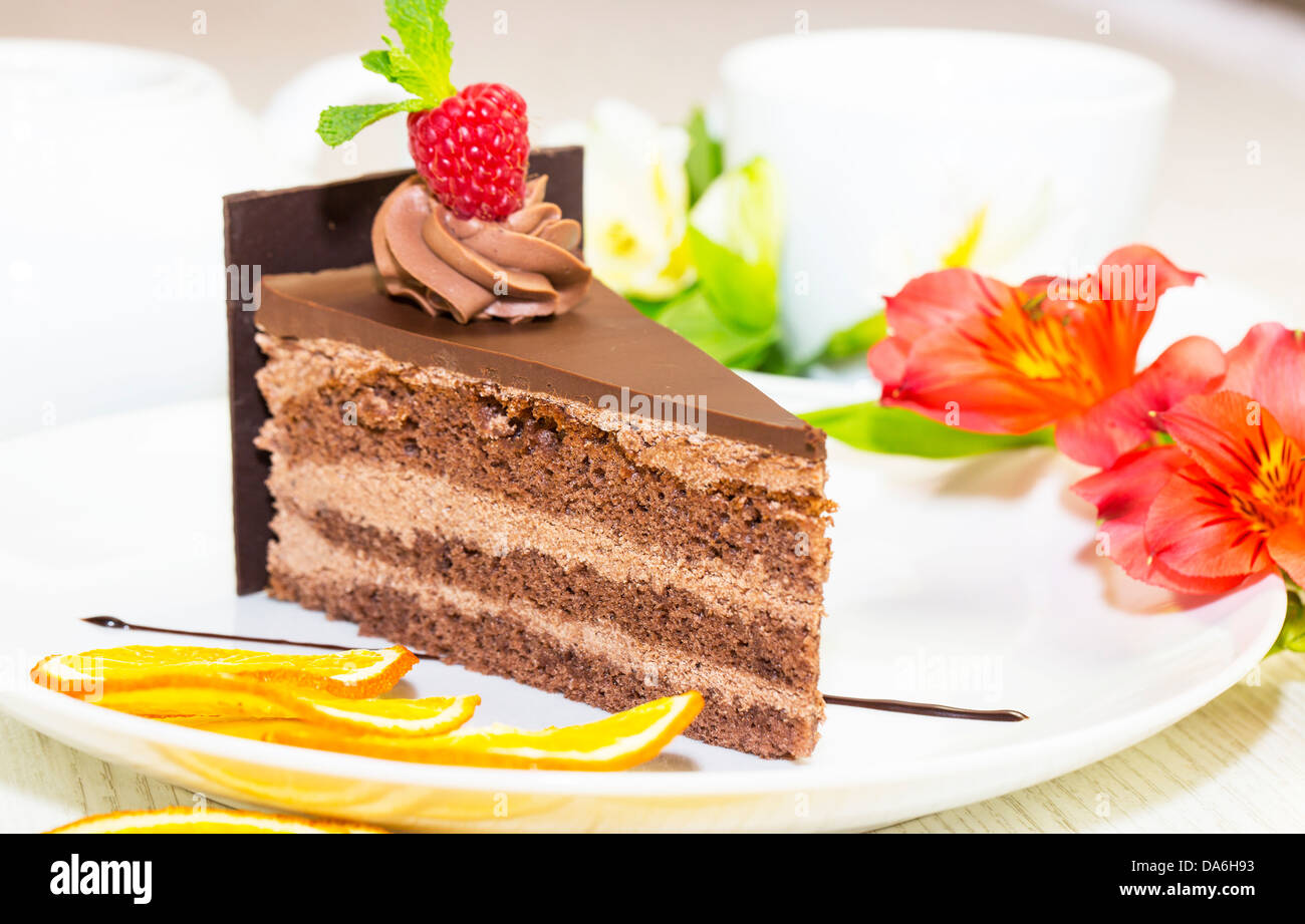 piece of chocolate cream cake on a white background in the restaurant ...