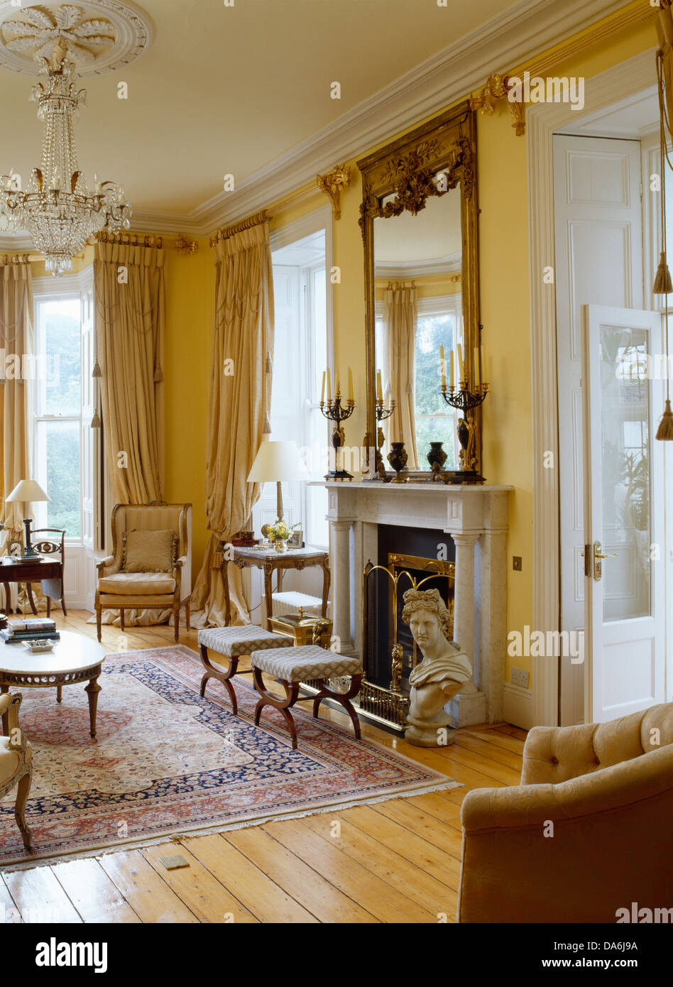 Marble Bust Beside Fireplace Below Large Antique Mirror In Grand