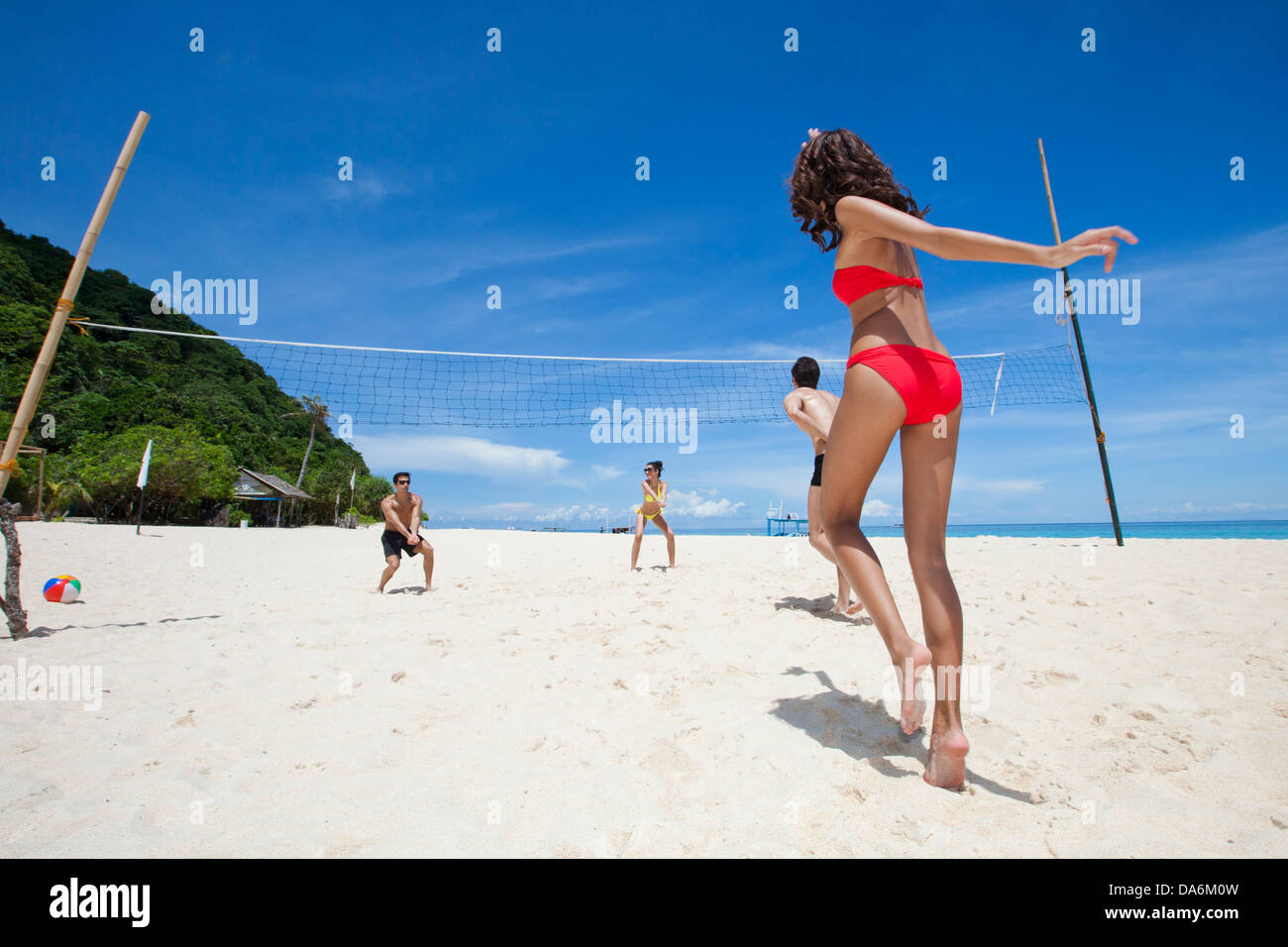 Friends playing beach volleyball. Stock Photo