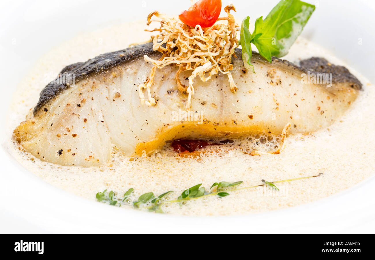 Roasted fillet of grilled fish in a white sauce Stock Photo - Alamy