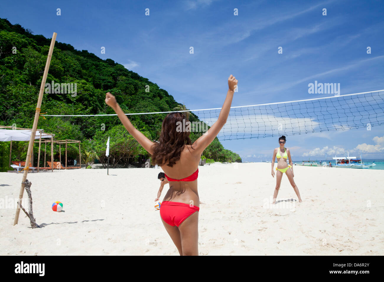 Friends playing beach volleyball. Stock Photo