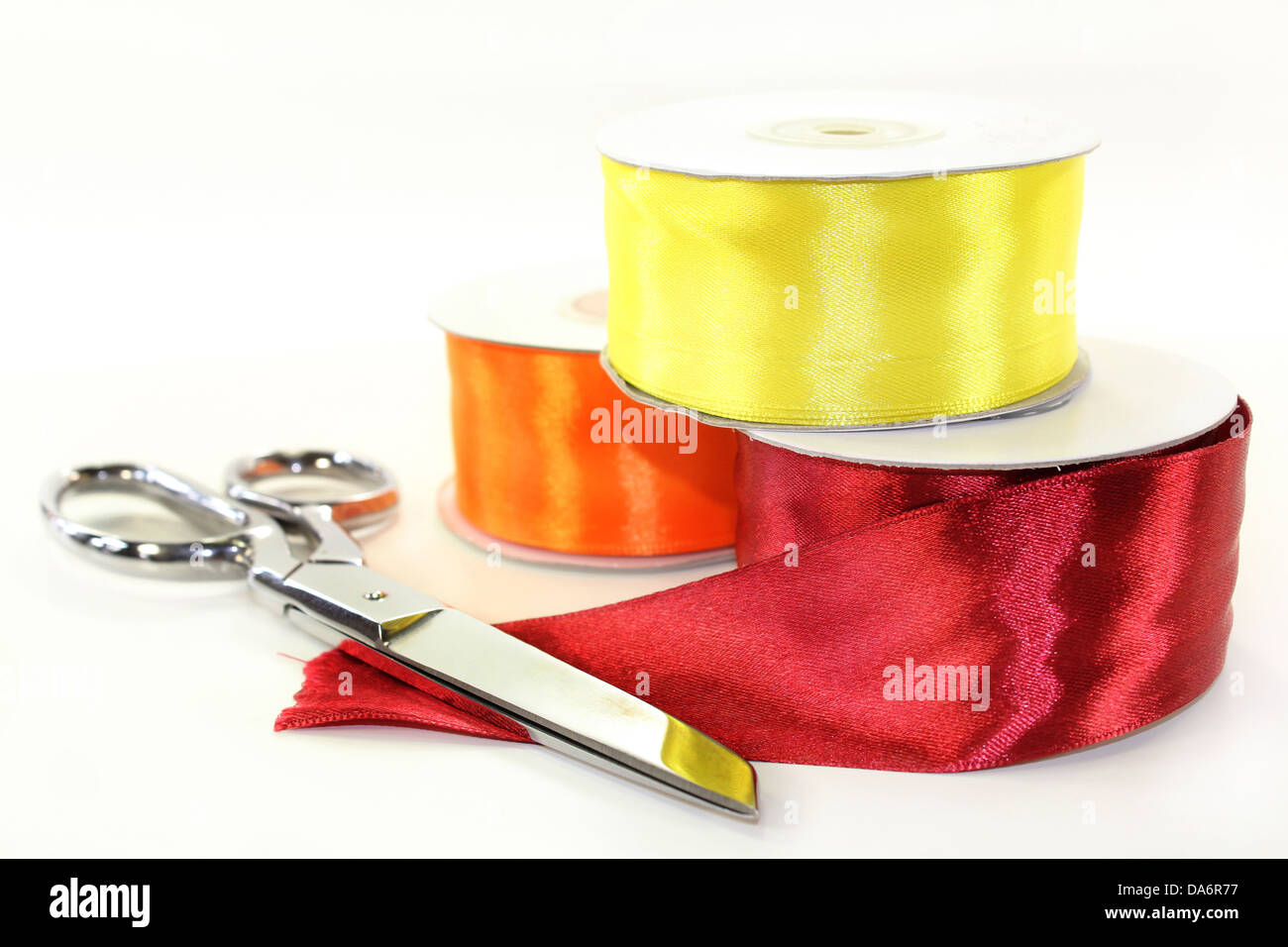 three rolls of ribbon in front of white background Stock Photo - Alamy