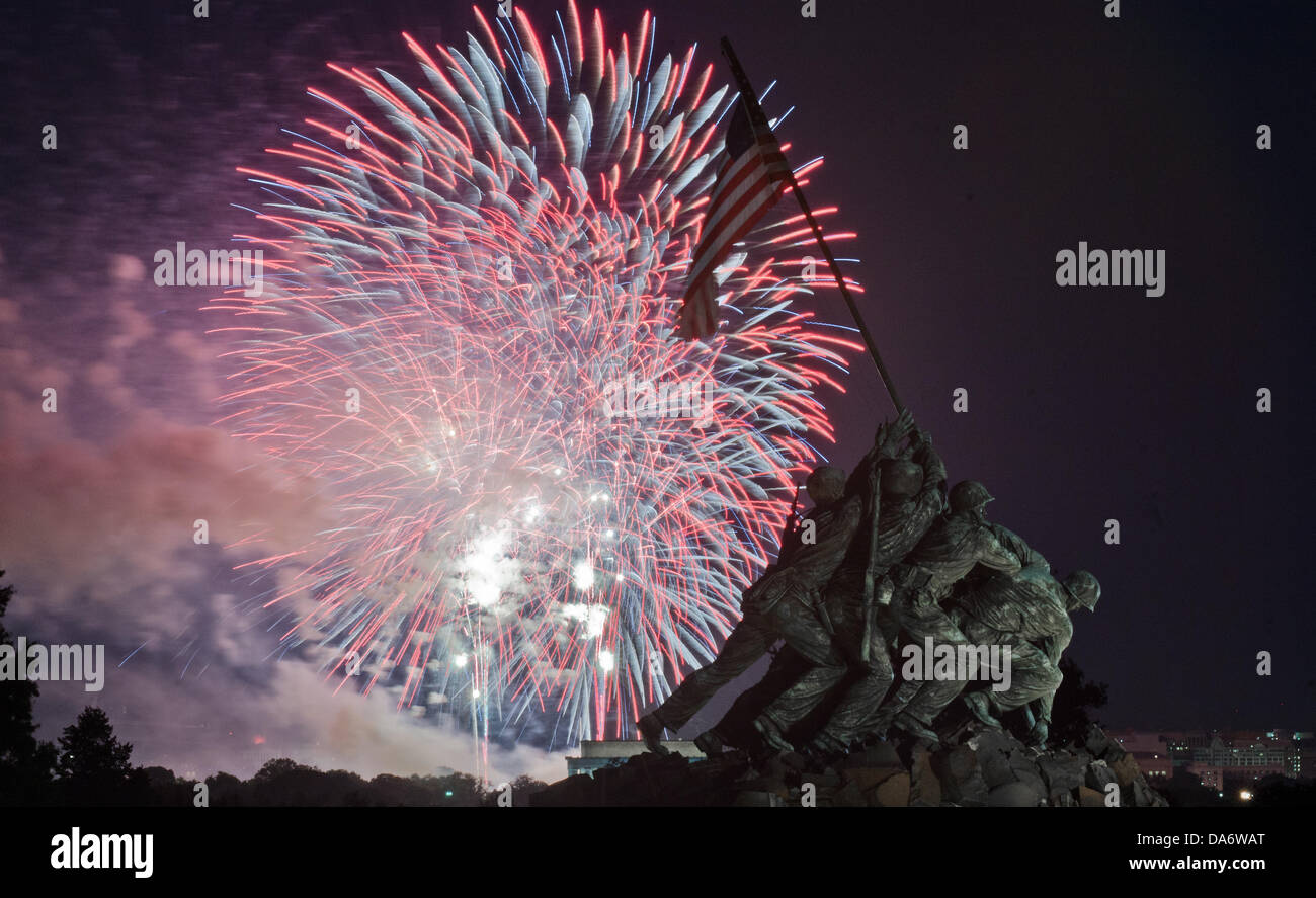 Fireworks celebrating Independence Day explode over Washington with the US Marine Corps Memorial in the foreground July 4, 2013 in Arlington, VA. Stock Photo