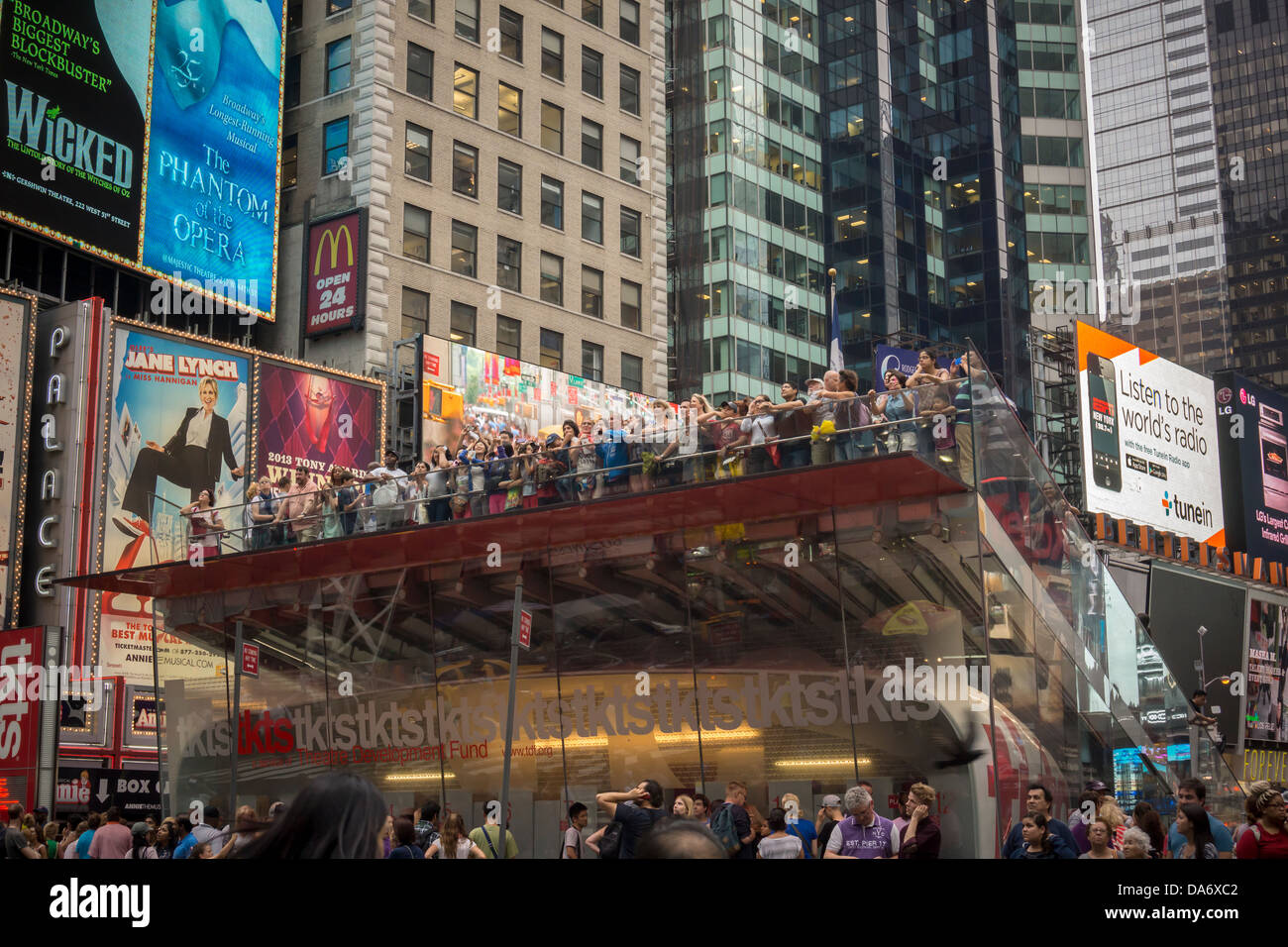 Visitors atop the TKTS ticket booth in Times Square in New York on Monday, July 1, 2013. (© Richard B. Levine) Stock Photo