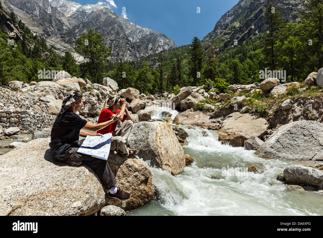 Hiker trekkers discussing route on trek in Himalayas mountains. Himachal Pradesh,India Stock Photo