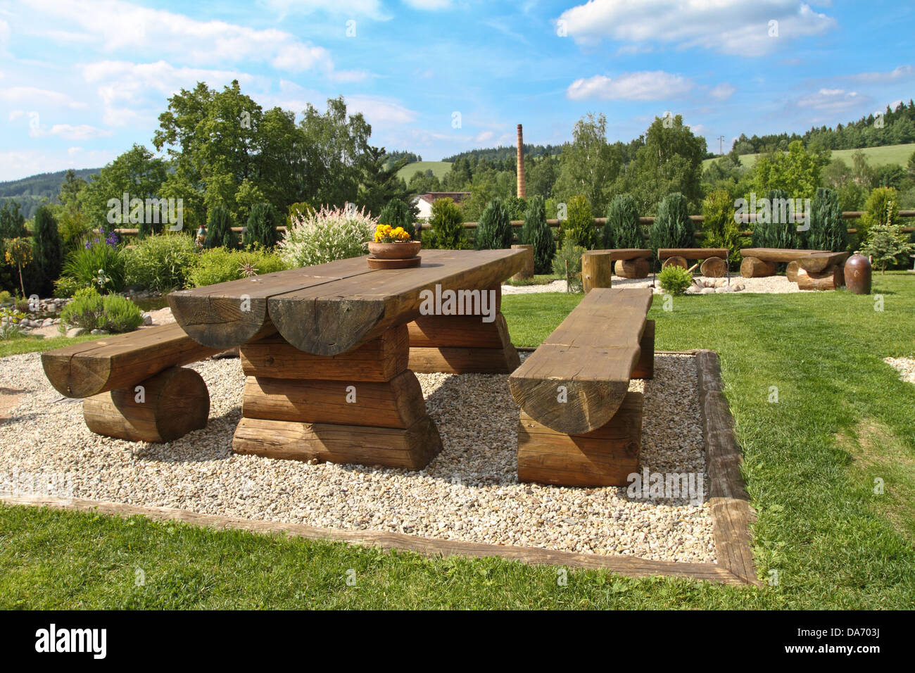 Wooden bench and table in the Czech country house garden Stock Photo