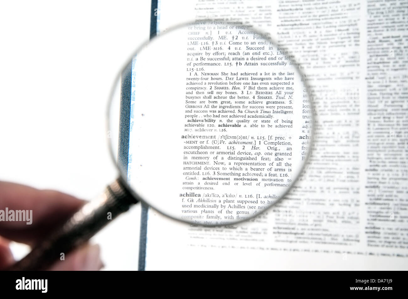 A magnifying glass on the word achievement on a dictionary Stock Photo