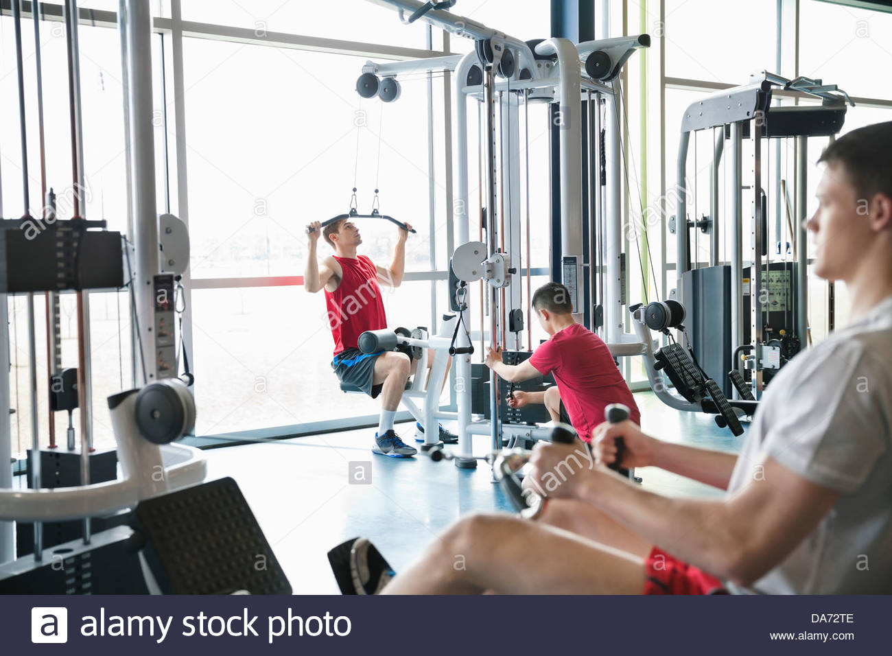 Men using weight machines in fitness center Stock Photo Alamy