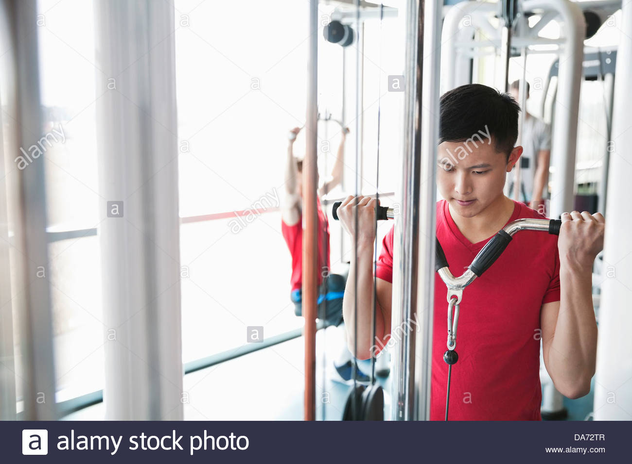 Man using weight machines in fitness center Stock Photo Alamy