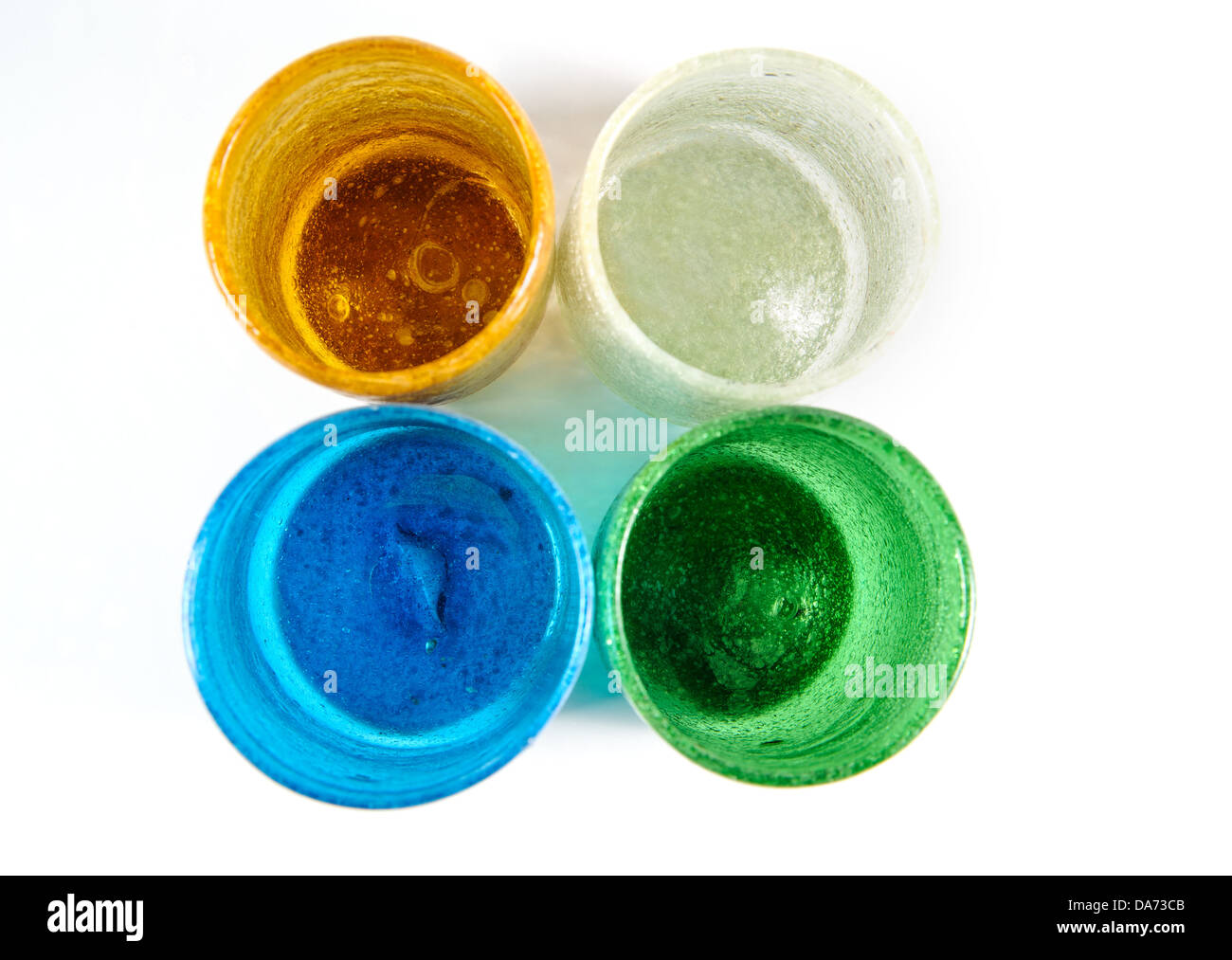 group of multi coloured glass cups on white background Stock Photo