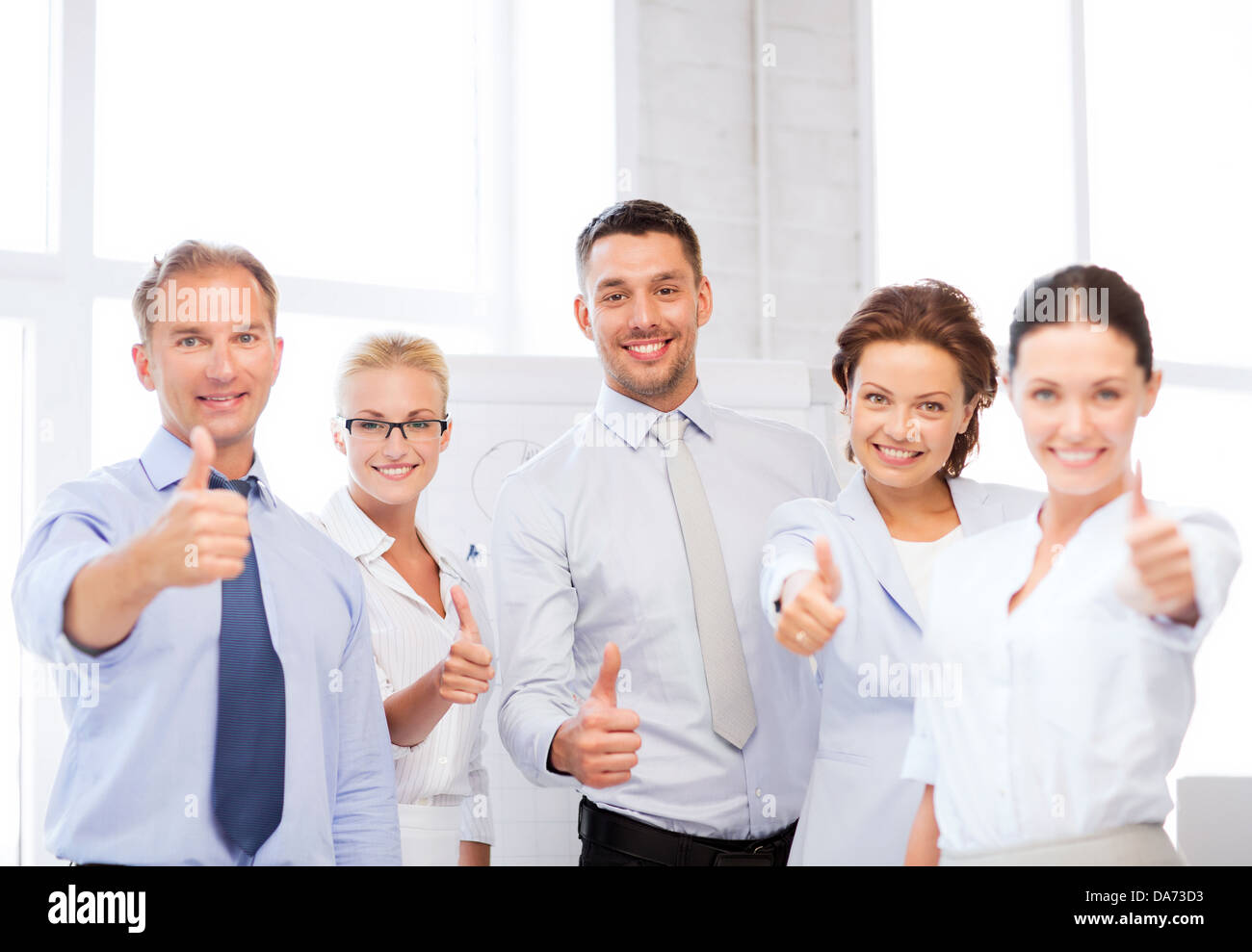 business team showing thumbs up in office Stock Photo - Alamy