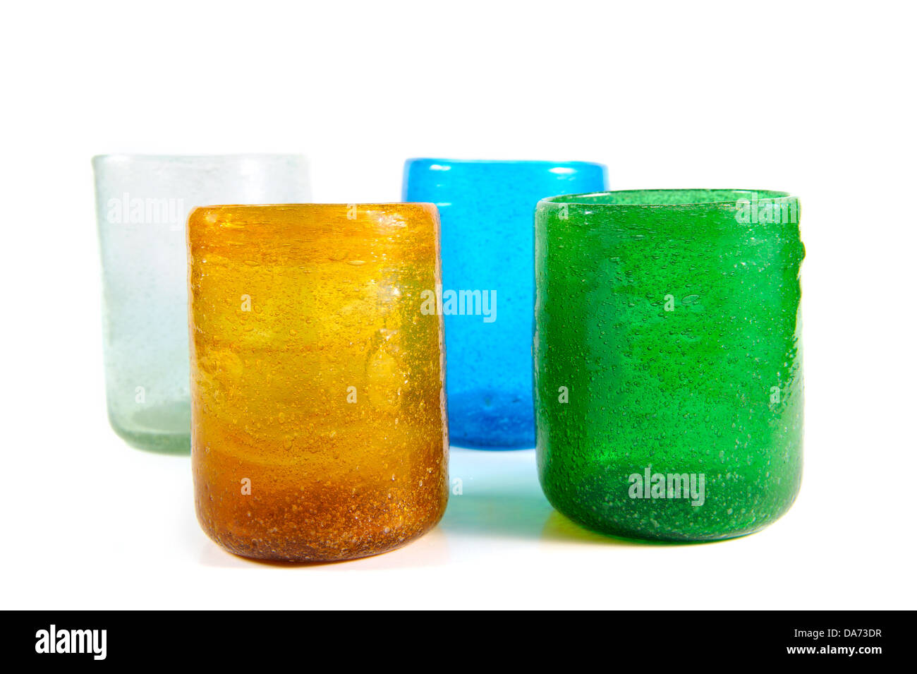 group of multi coloured glass cups on white background Stock Photo
