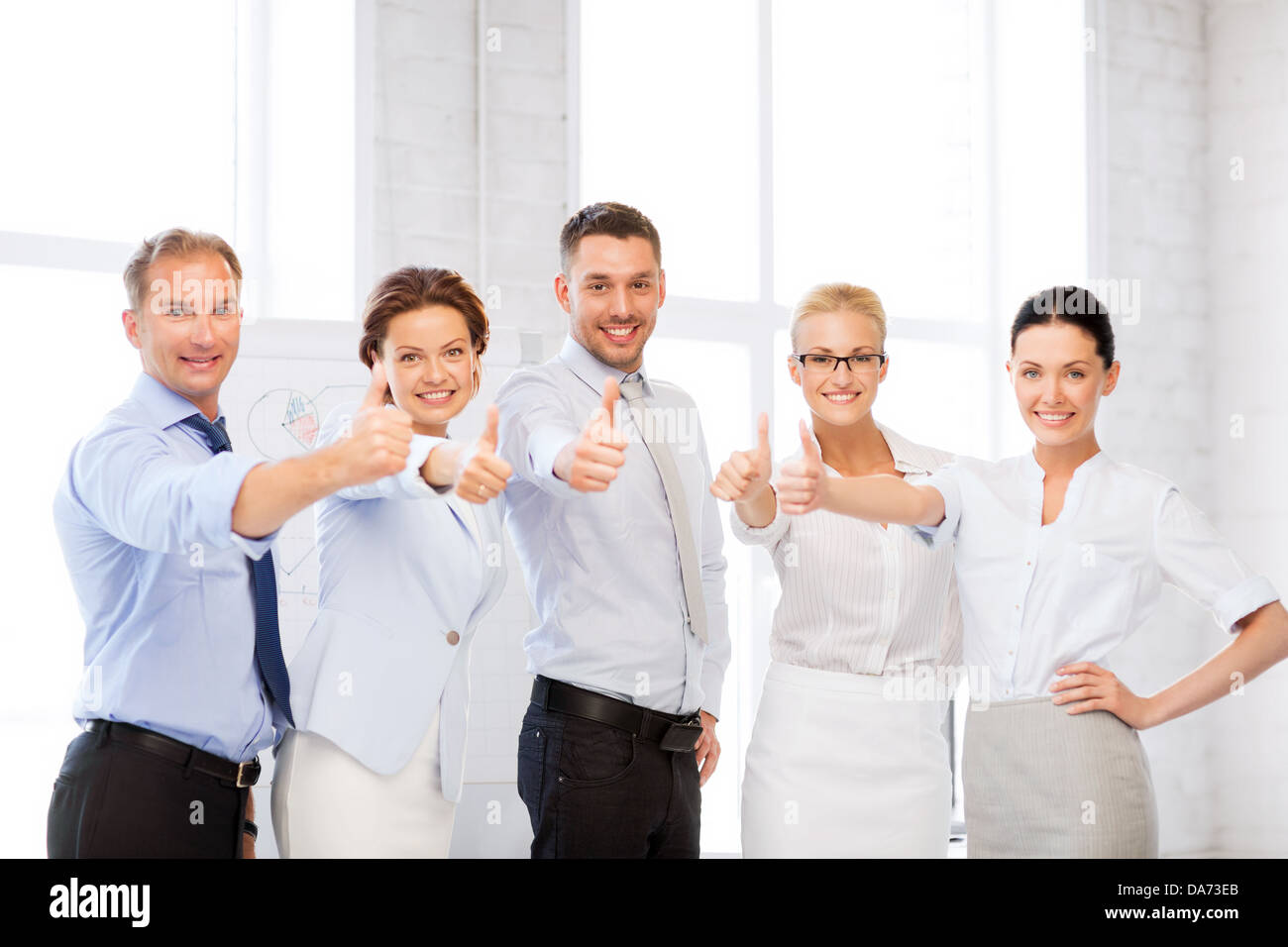 business team showing thumbs up in office Stock Photo - Alamy
