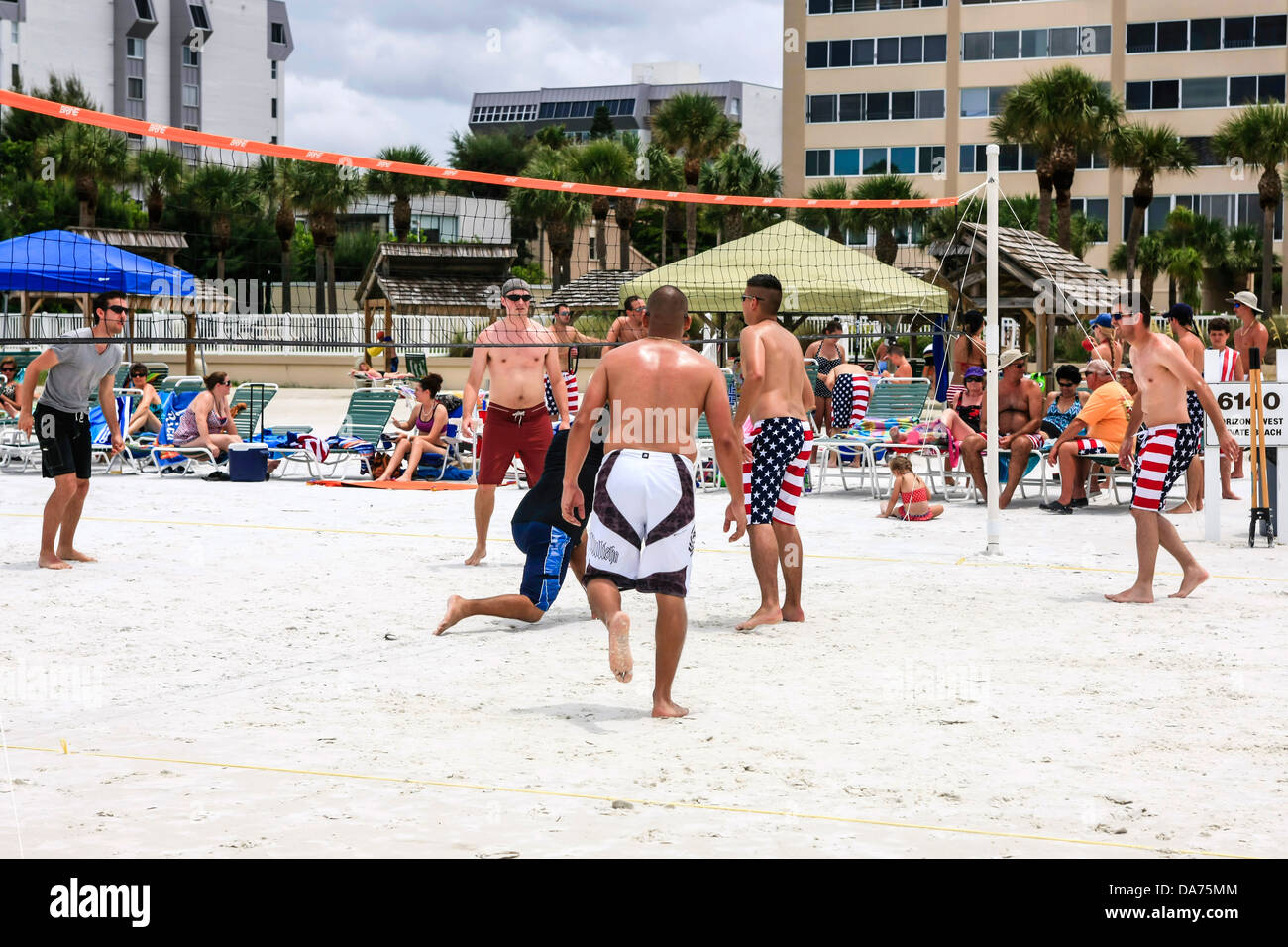 College guys playing volleyball and wearing patriotic Stars and Stripes
