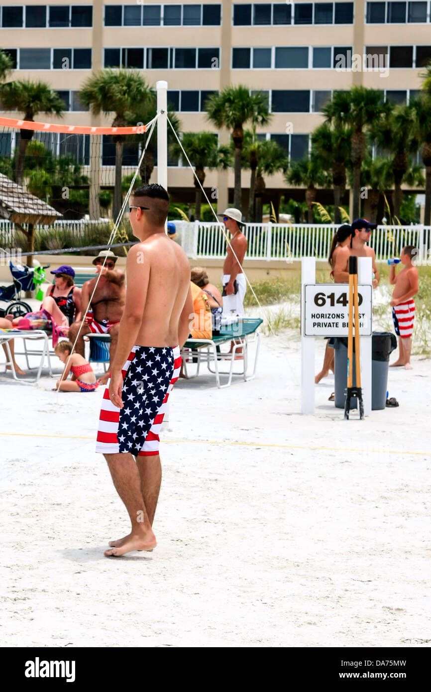 College guys playing volleyball and wearing patriotic Stars and Stripes