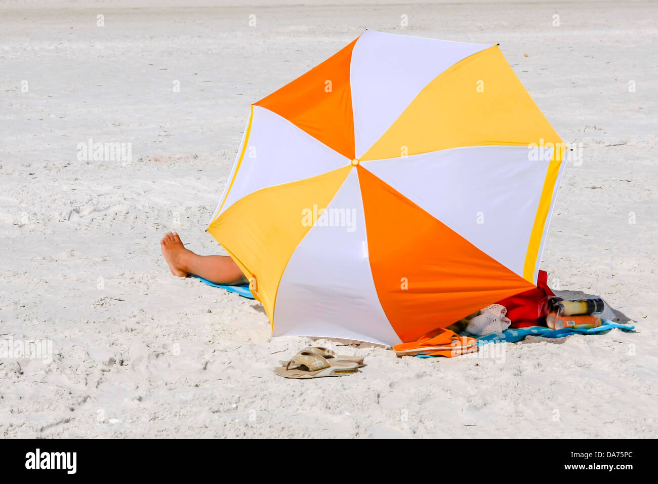 A woman sits beneath a beach Umbrella on Siesta Key Beach Florida Stock Photo Alamy