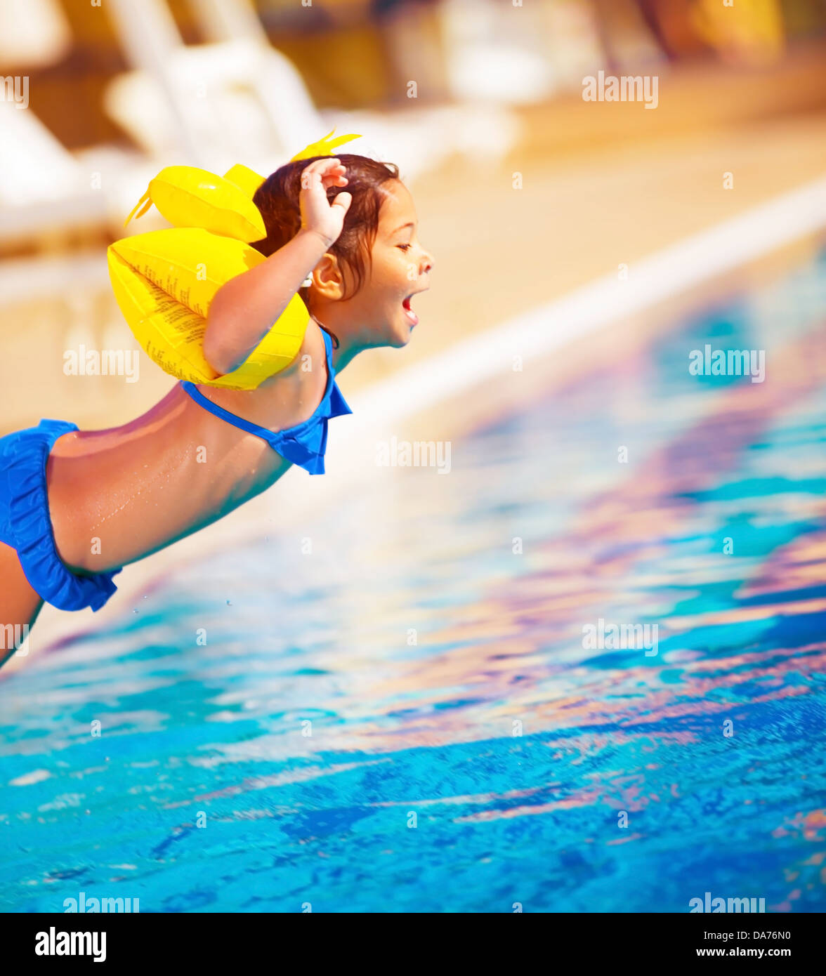 Little girl jumping into the pool, active lifestyle, sportive sweet child, water amusement