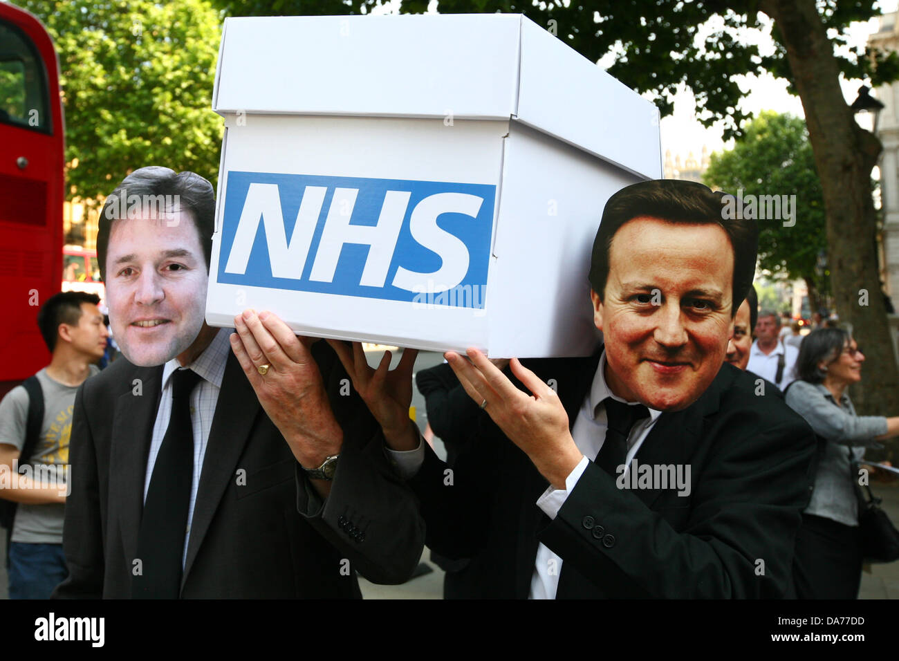 London, UK. 5th July, 2013. Medical staff march with a coffin to Downing Street to protest privatisation NHS on the 65th anniversary of it's founding  Credit:  Mario Mitsis / Alamy Live News Stock Photo