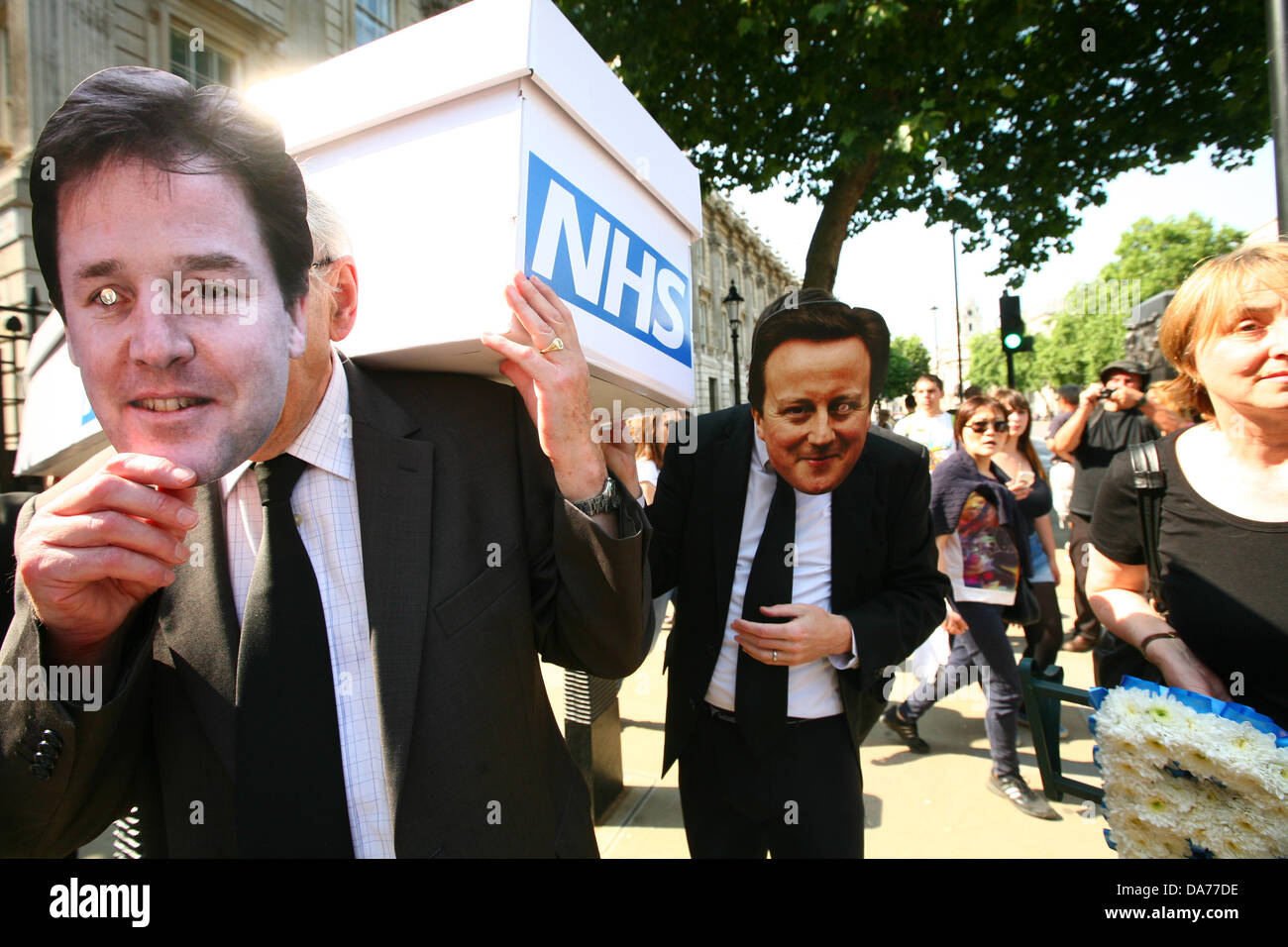 London, UK. 5th July, 2013. Medical staff march with a coffin to Downing Street to protest privatisation NHS on the 65th anniversary of it's founding  Credit:  Mario Mitsis / Alamy Live News Stock Photo