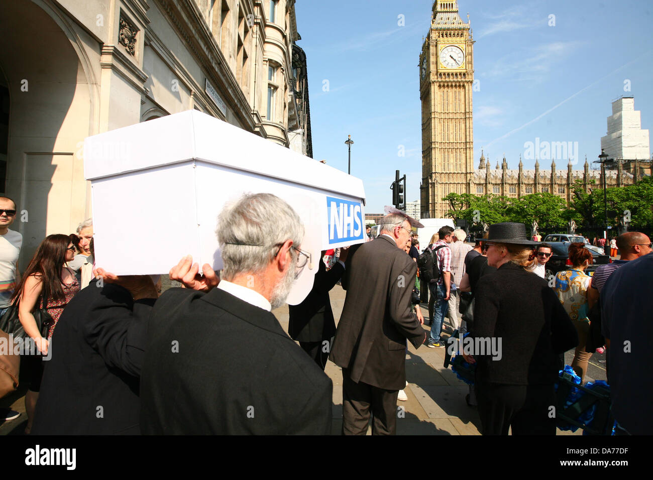 London, UK. 5th July, 2013. Medical staff march with a coffin to Parliament to protest privatisation NHS on the 65th anniversary of it's founding  Credit:  Mario Mitsis / Alamy Live News Stock Photo