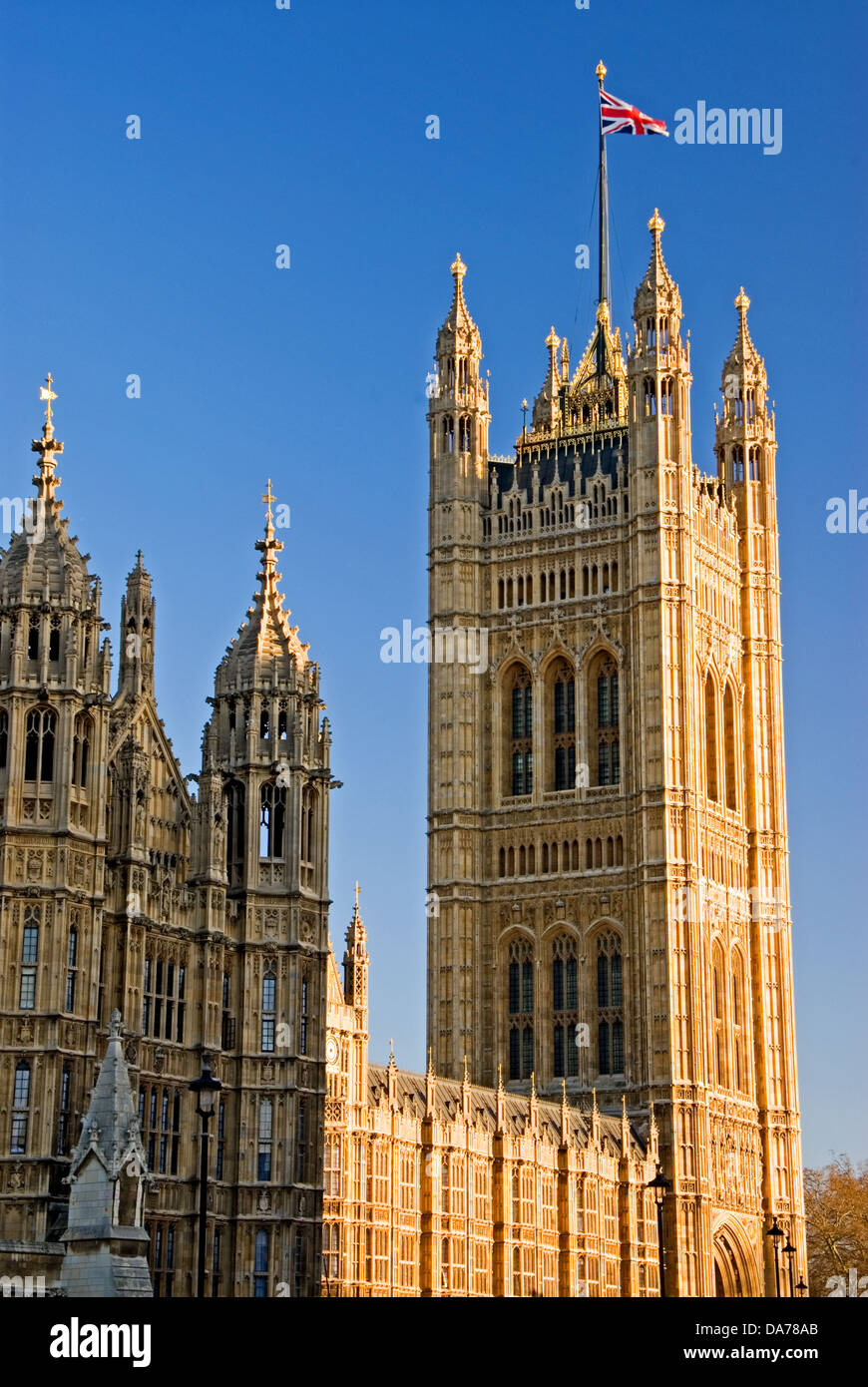 Ornate tower at West entrance of Palace of Westminster with flag of Great Britain flying. Stock Photo
