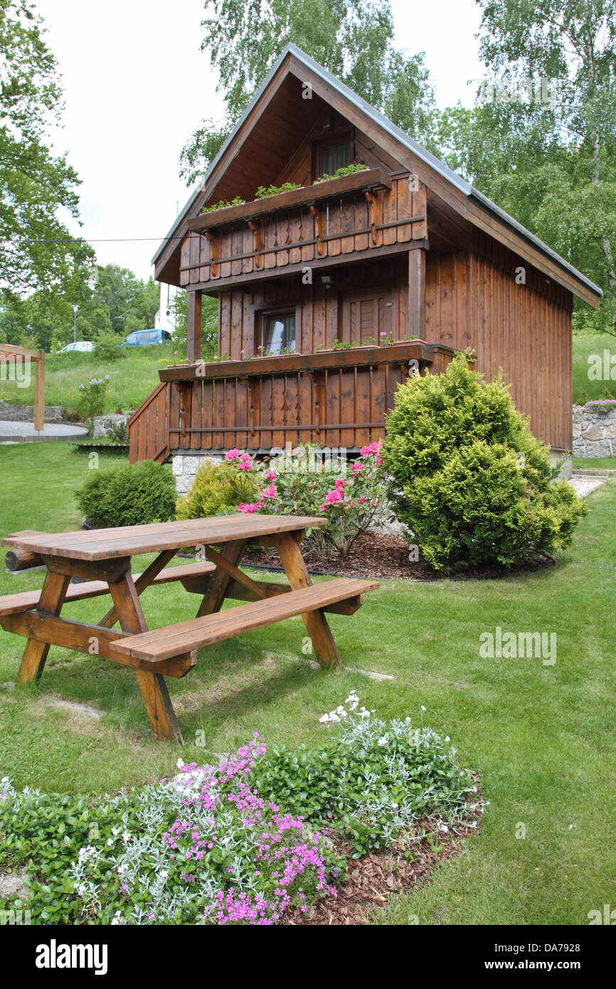 wooden cottage in the summer garden Stock Photo - Alamy