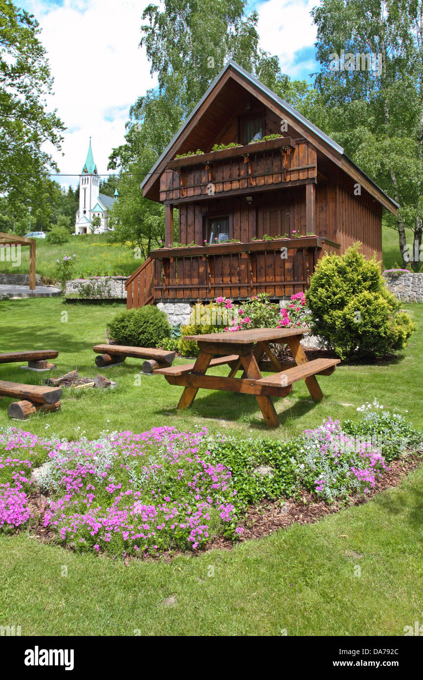 wooden cottage in the summer garden Stock Photo - Alamy