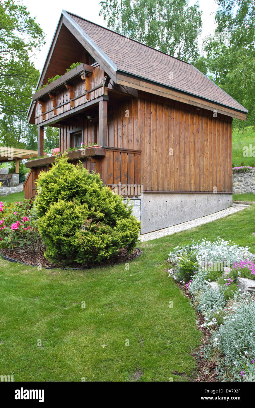 wooden cottage in the summer garden Stock Photo - Alamy