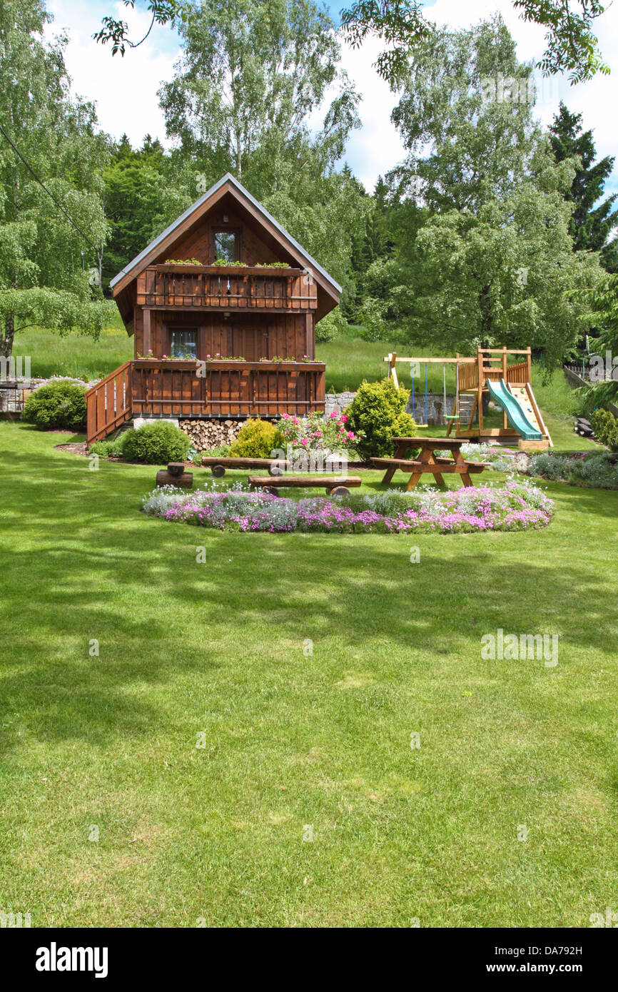 wooden cottage in the summer garden Stock Photo - Alamy