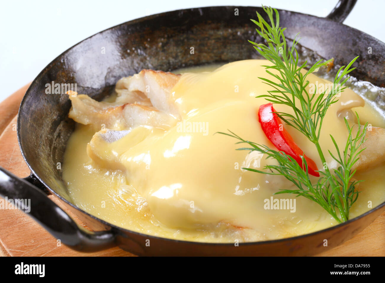 Pan-seared white fish with rich sauce Stock Photo - Alamy