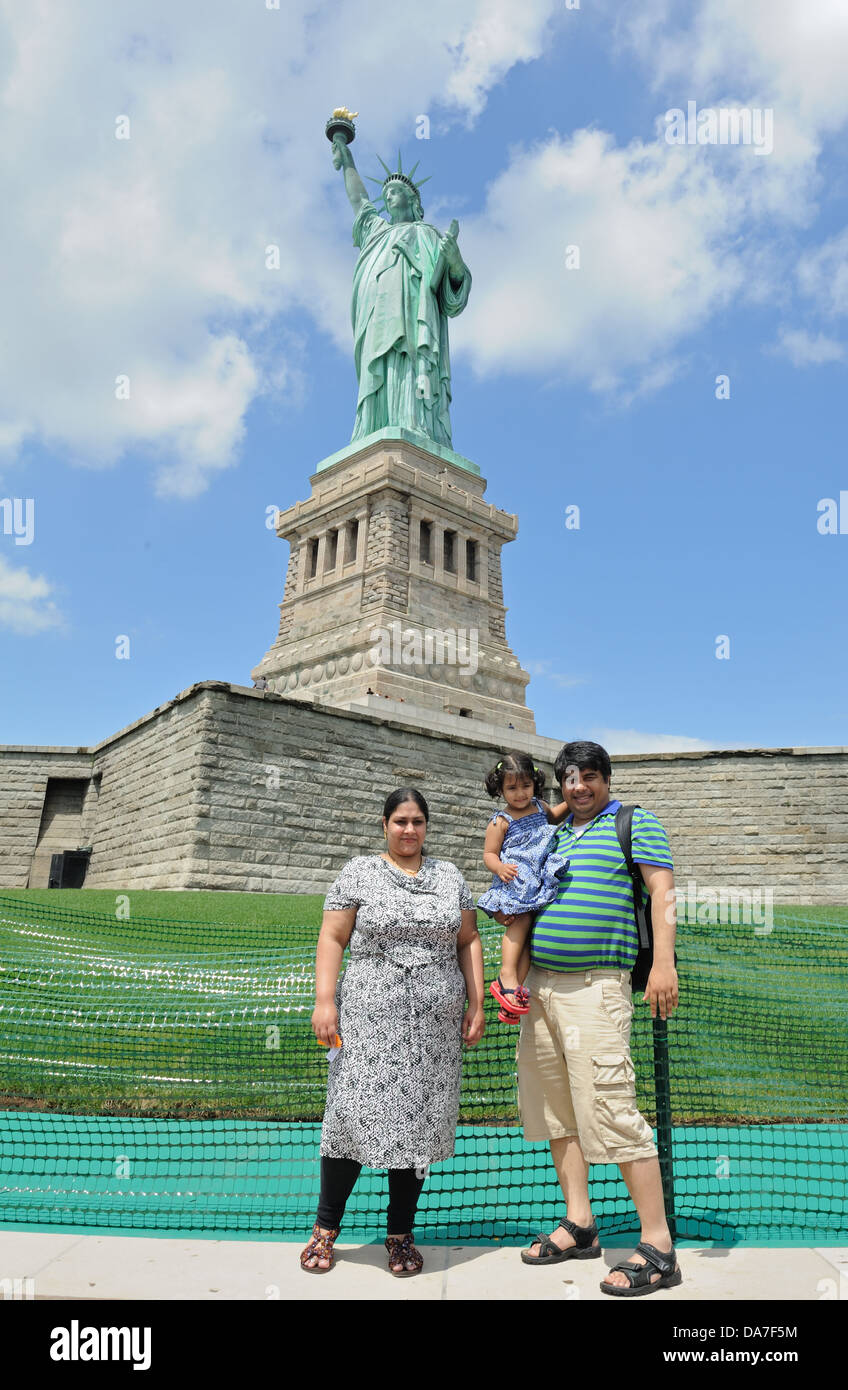 Visitors posing for family portraits in front of the Statue of Liberty on Liberty Island in New York harbor on July 4, 2013. Stock Photo