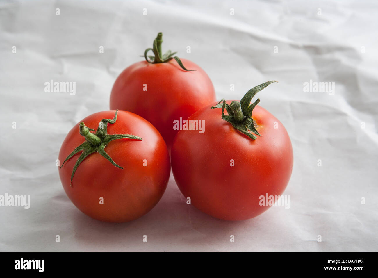 red ripe tomatoes on butcher paper Stock Photo