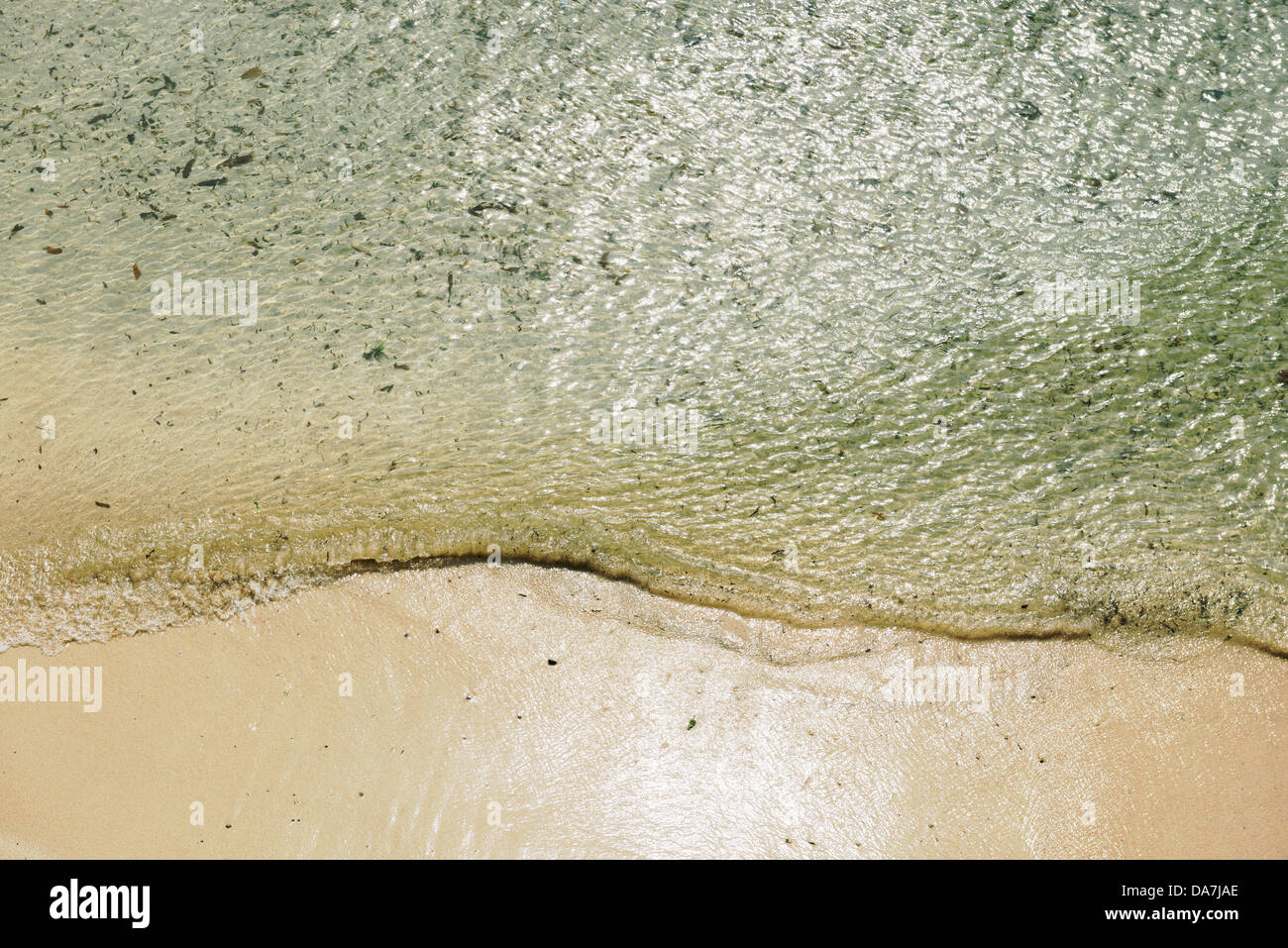 Waves from above lapping against the shore at St. Ives, Cornwall, Southwest England on a bright June day. Stock Photo