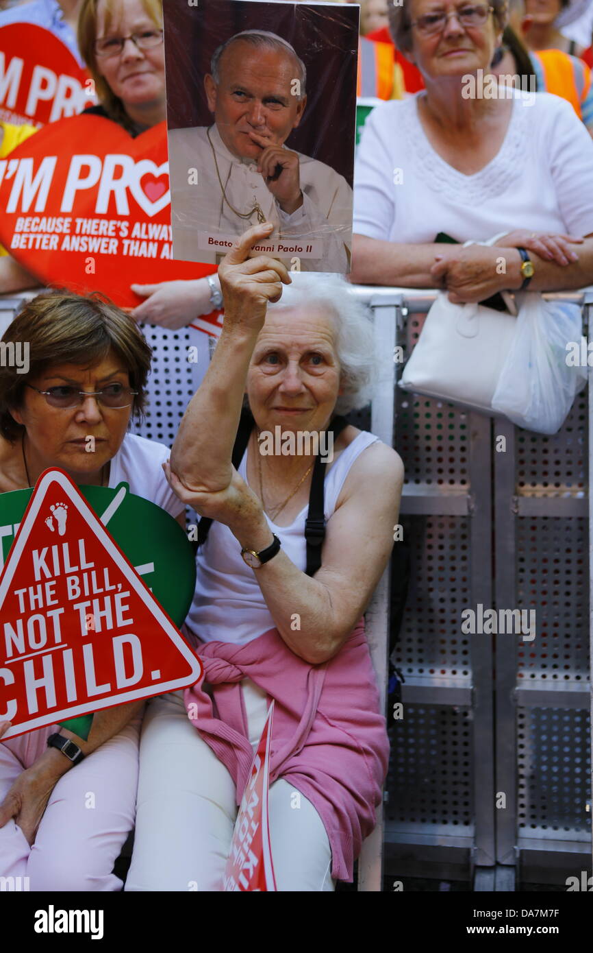 Dublin, Ireland. 6th July 2013. A woman holds a placard that shows a picture of the late Pope John-Paul II. Thousands of pro-life activists attended the 7th annual 'All-Ireland Rally for Life' outside Dail Eireann (Irish Parliament), protesting under the motto 'Kill the bill not the child' against the Protection of Life During Pregnancy Bill 2013, which is discussed in the parliament and will regulate abortion in Ireland. Credit:  Michael Debets/Alamy Live News Stock Photo