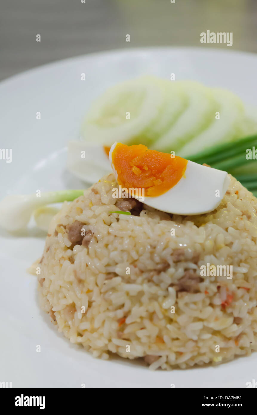 fried rice with pork and boiled egg served with fresh vegetable Stock Photo