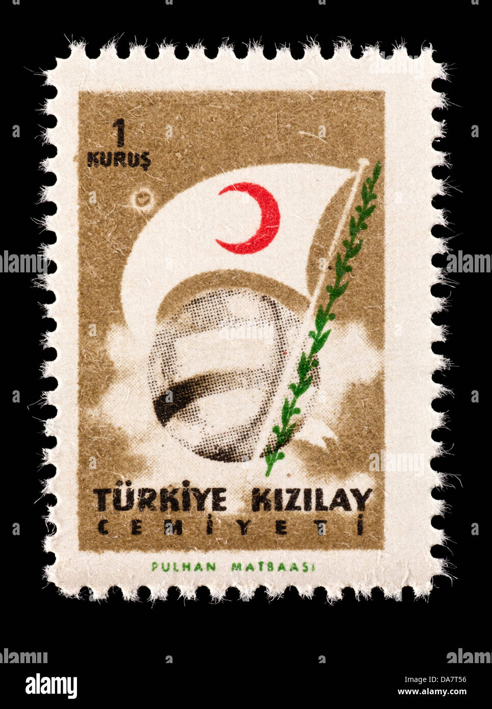 Postal tax stamp from Turkey depicting a globe and the flag of the Red Crescent. Stock Photo