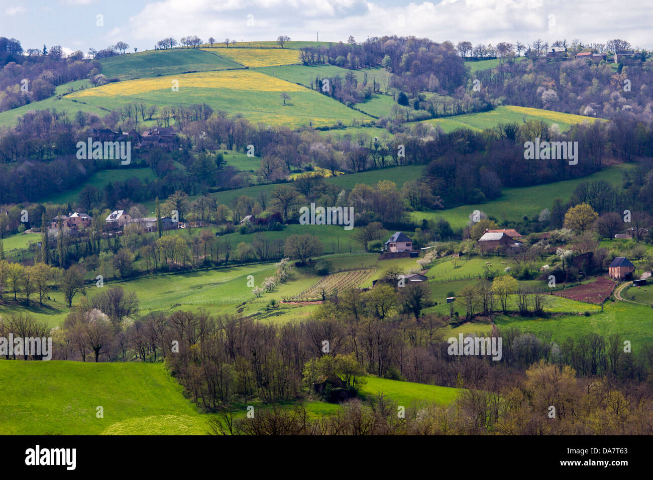 Bucolic scenic landscape with hilly pastures and farmhouses in Midi-Pyrenees region of France Stock Photo