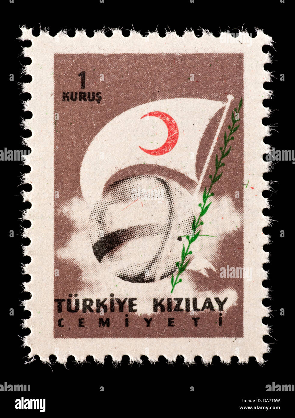 Postal tax stamp from Turkey depicting a globe and the flag of the Red Crescent. Stock Photo