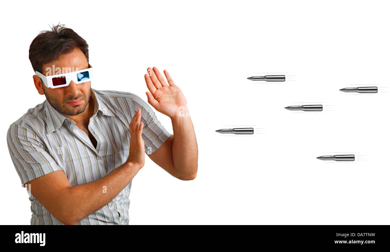 Portrait Of A Young Man Wearing 3d Glasses frightened by bullets Stock Photo