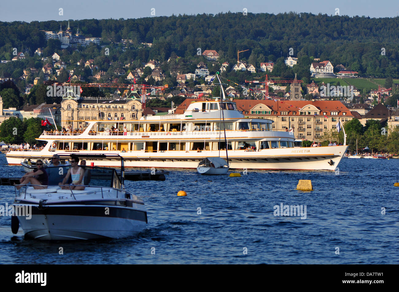 Zurich, Switzerland, 6th July 2013, in the center of Zurich,  one of the biggest European festival is taking place for three days. Parties, Carnival, fairground attractions, market, food and drink stands everywhere. boat trip for zurich fastival on Zurich lake, merchants are along the lake. Credit:  momo leif/Alamy Live News Stock Photo