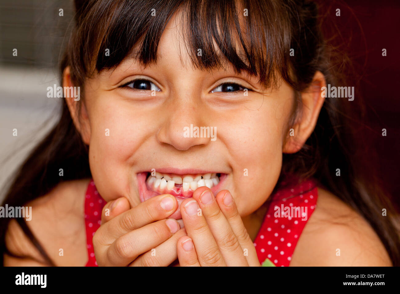Cute little girl who is excited about losing her first tooth Stock Photo
