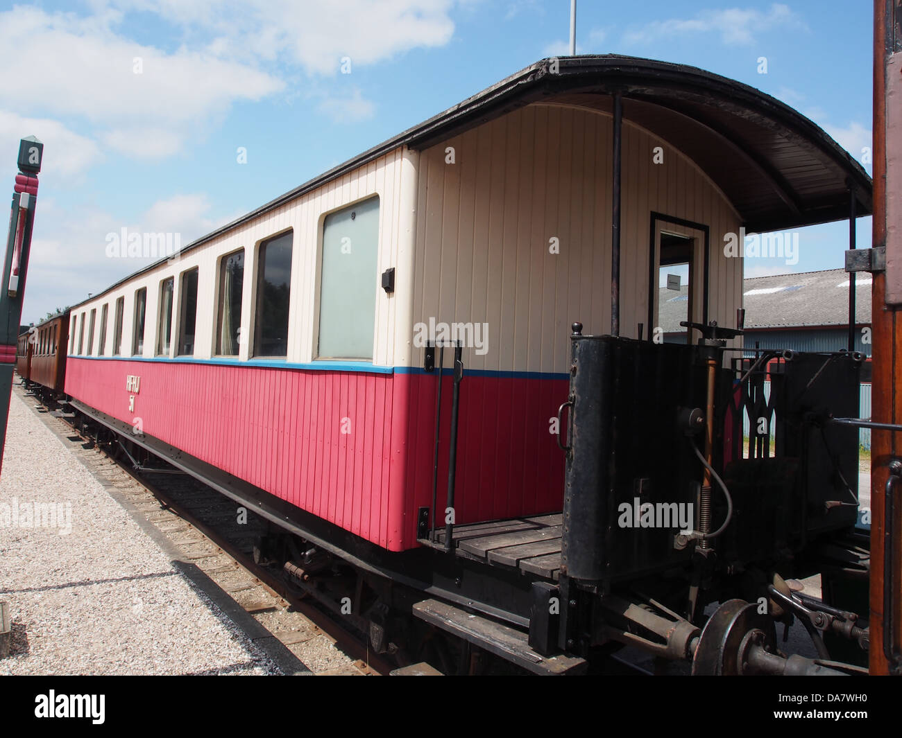 A Danish railroad car from the Mariager-Handest Veteranjernbane, showcasing a vintage railway carriage. The photo captures the design and historical significance of this railcar used on the historic line in Denmark. Stock Photo