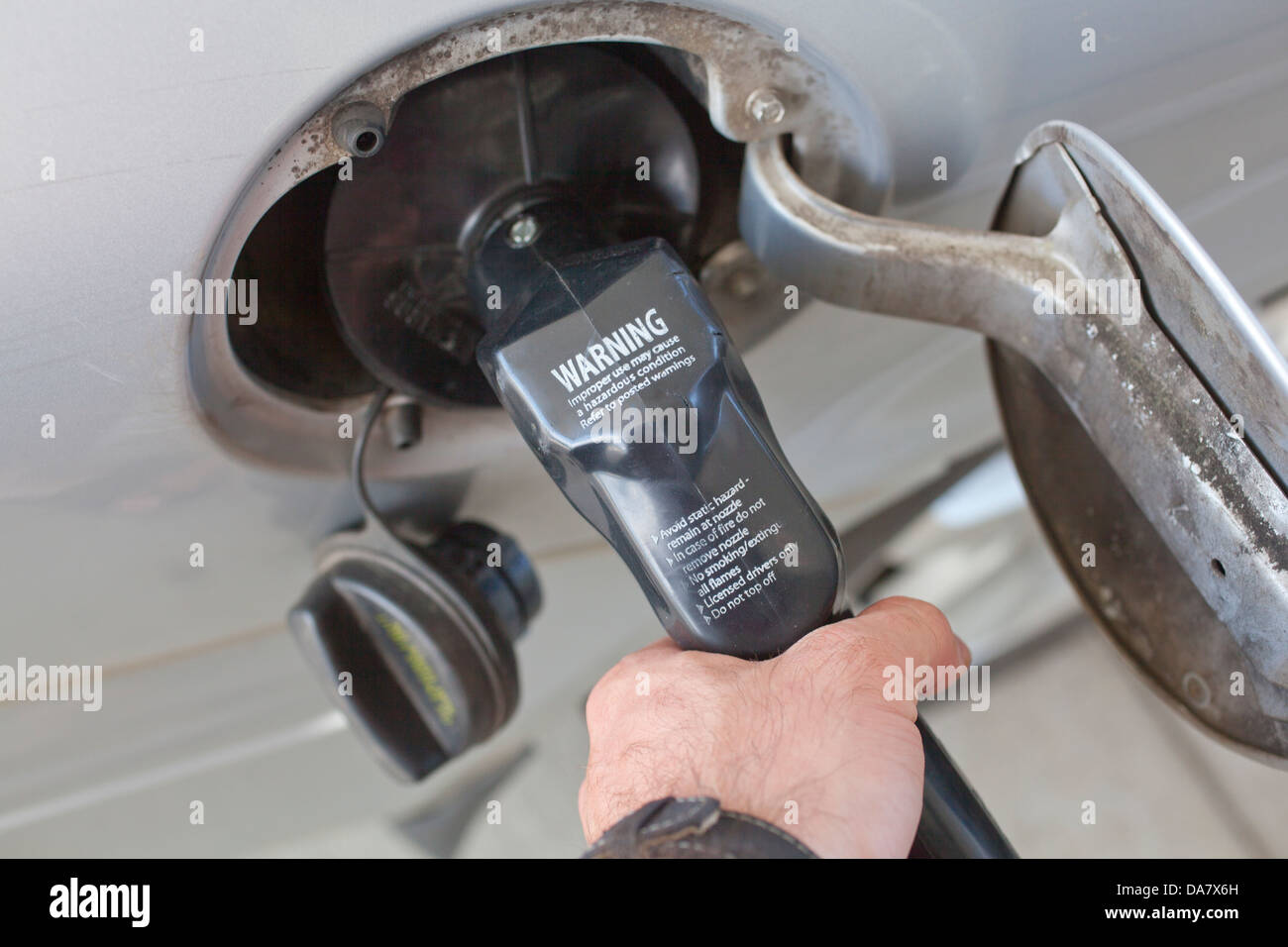 A gas pump inserted into a vehicle fuel tank opening Stock Photo Alamy