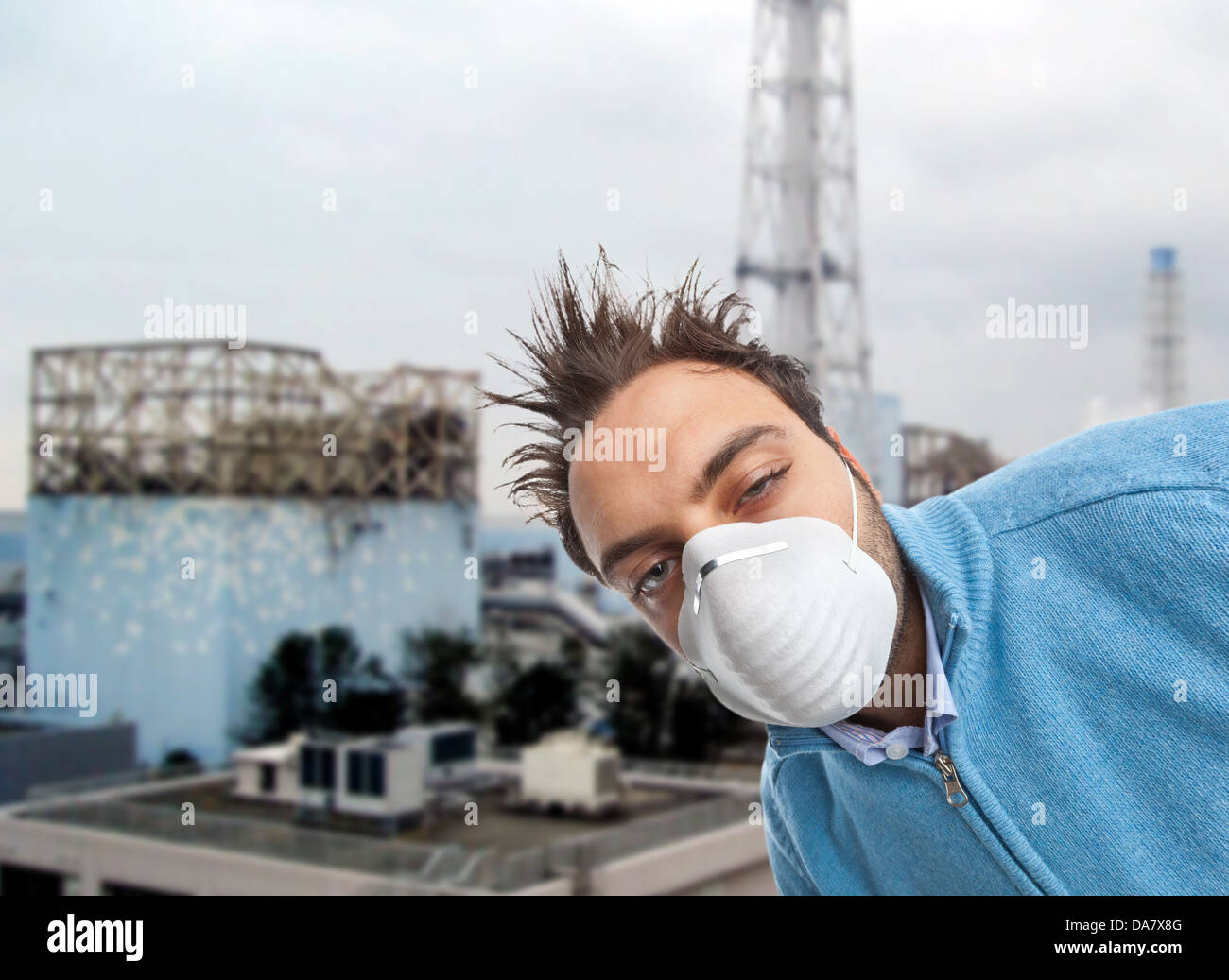 Young boy with mask respiratory protection near nuclear reactors Stock Photo