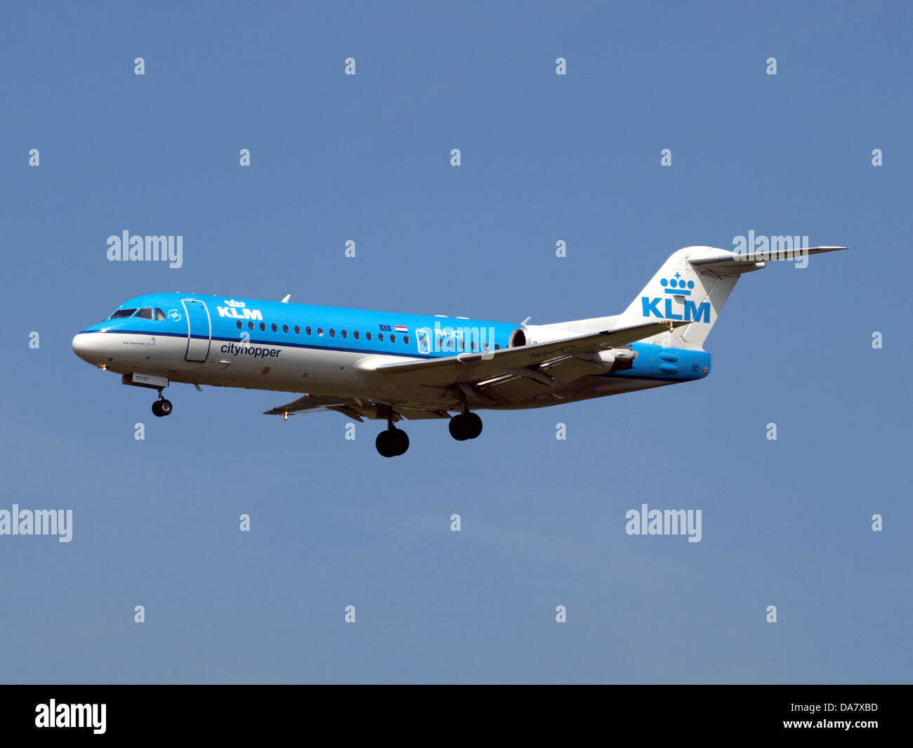 PH-JCT is a Fokker 70 aircraft operated by KLM Cityhopper. The plane is seen during takeoff or landing at Amsterdam Airport Schiphol, a major international hub in the Netherlands known for its high traffic and modern facilities. Stock Photo