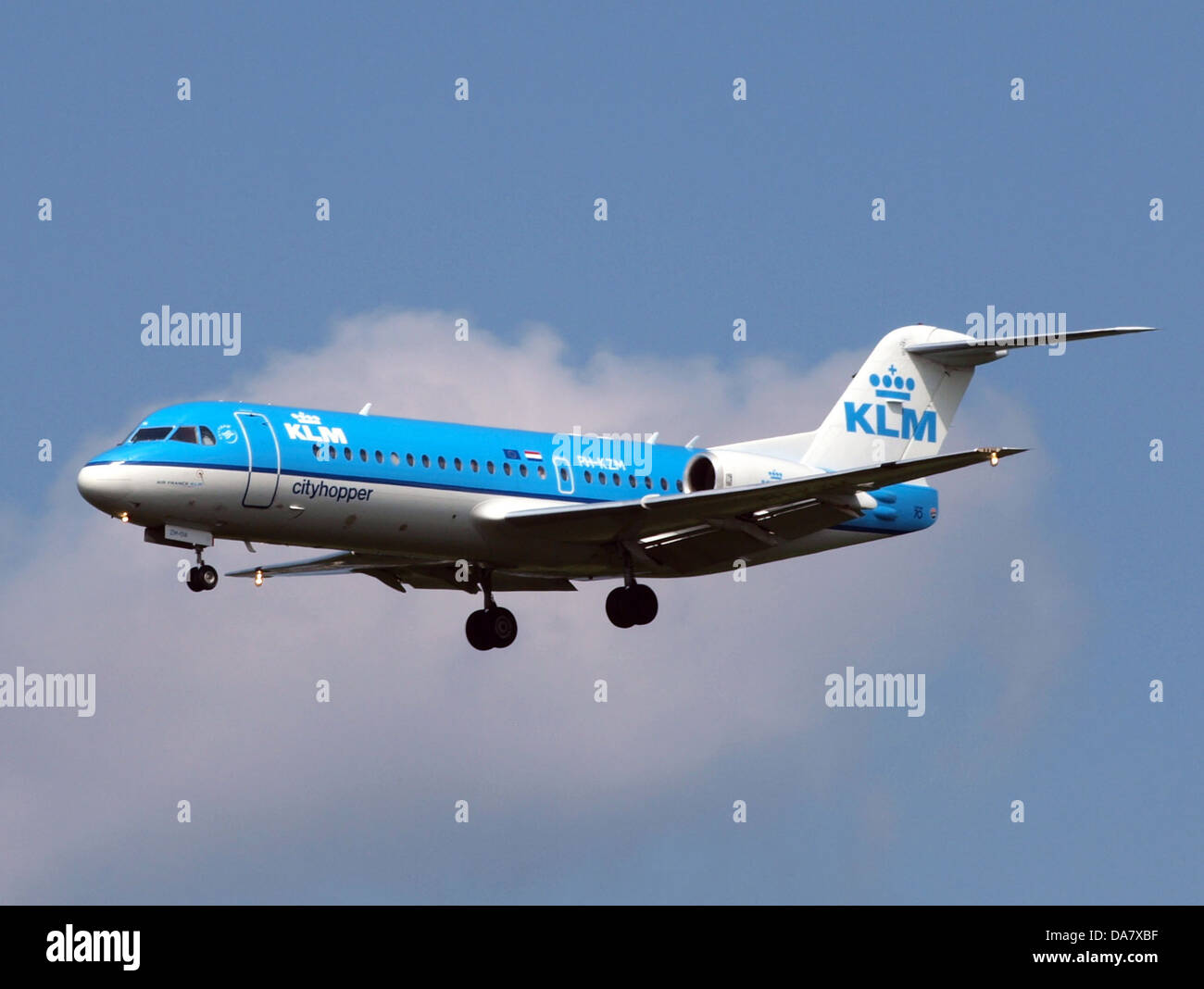 PH-KZM is a Fokker 70 aircraft operated by KLM. Seen here landing at Schiphol Airport in Amsterdam, the Fokker 70 is a regional jetliner used for short-haul flights. It is known for its fuel efficiency and compact design, catering to domestic and European routes. Stock Photo
