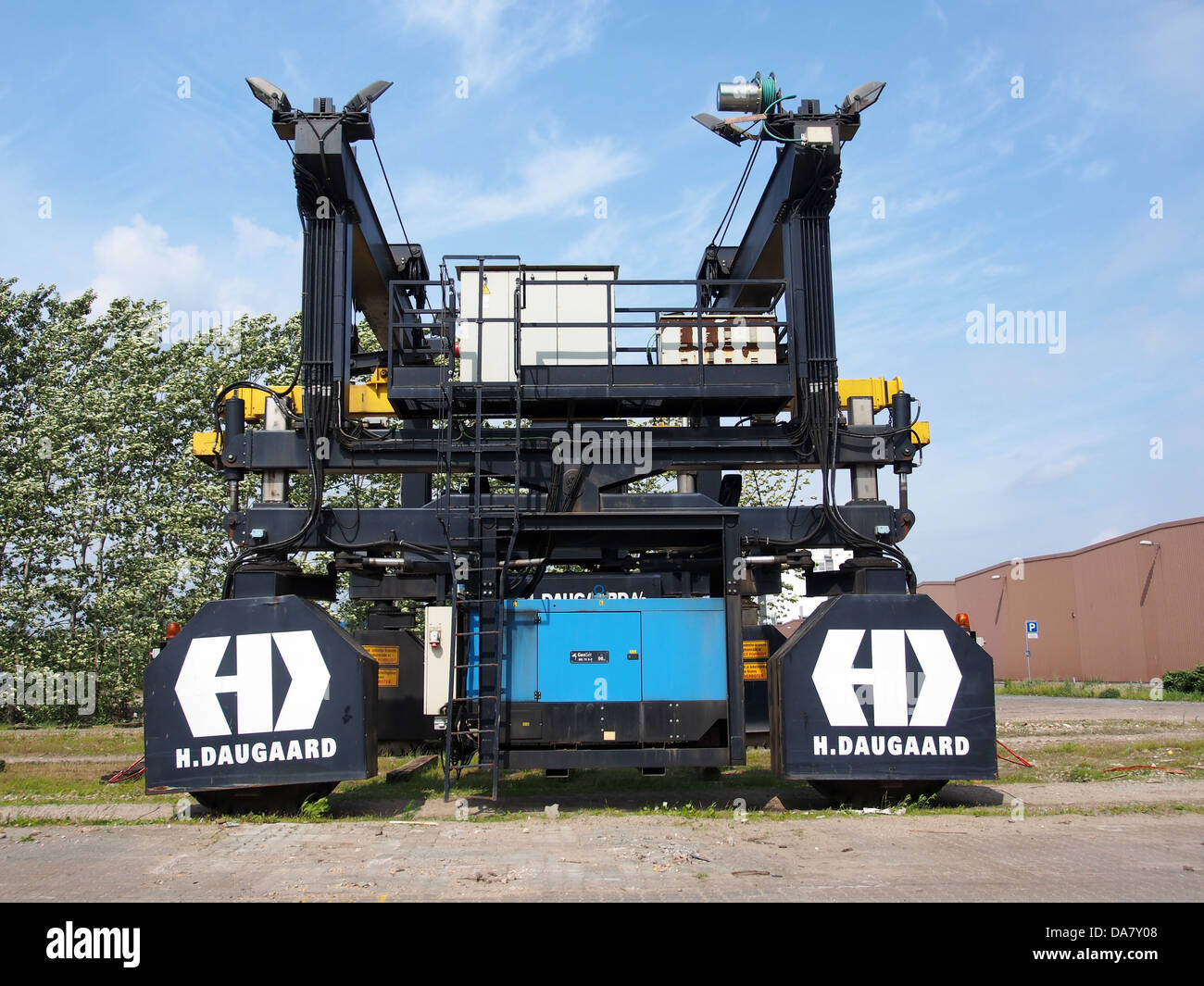 A Rubber Tyred Gantry Crane (RTG) 41505 is used in container terminals for moving shipping containers efficiently. The crane is a vital piece of equipment in modern logistics and cargo handling. Stock Photo
